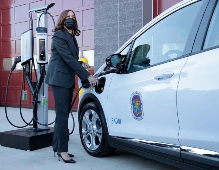 Vice President Kamala Harris plugs an electric vehicle into a charging station in Brandywine, Maryland, on Dec. 13, 2021.