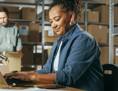 Male and Female Warehouse Inventory Managers Talking,
