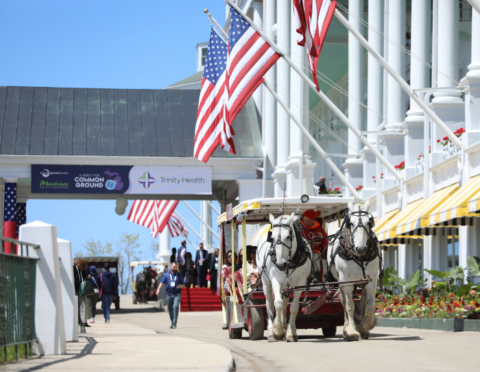 Grand Hotel's busy front porch with full horse taxi transporting guests at the 2026 Mackinac Policy Conference