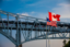 Blue Water Bridge, Port Huron, Michigan. West end of bridge over the St. Clair River connecting Sarnia, Ontario, Canada and the United States. Bridge is located at the extreme southern tip of Lake Huron. The flags of the USA and Canada waving in the foreground