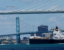 A ship passes the Gordie Howe International Bridge and Ambassador Bridge on June 12. (Jeff Kowalsky/Bloomberg)