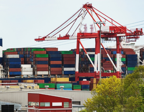 A massive container ship loading and unloading at port.