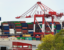 A massive container ship loading and unloading at port.